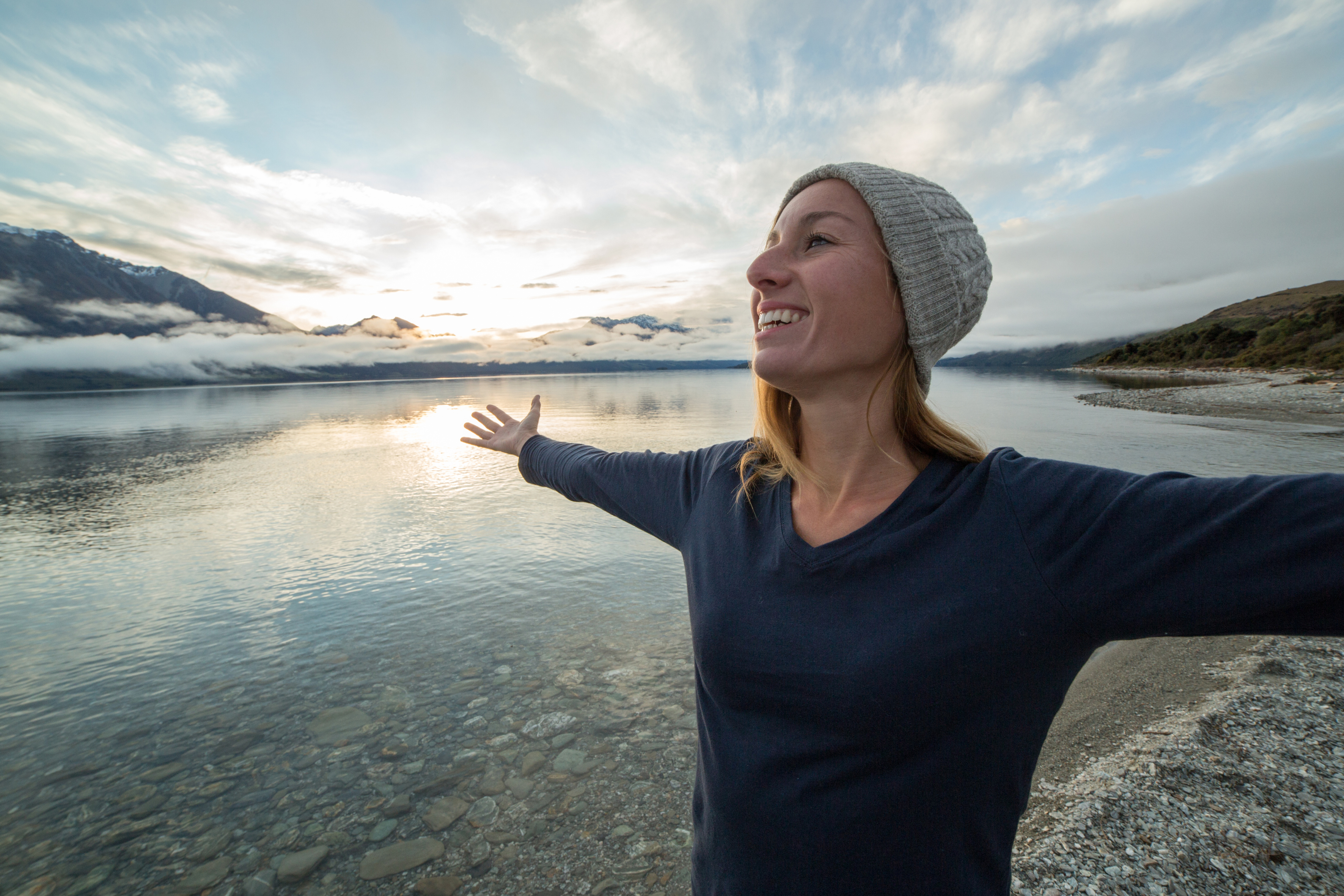 Imagine of woman with arms out on beach