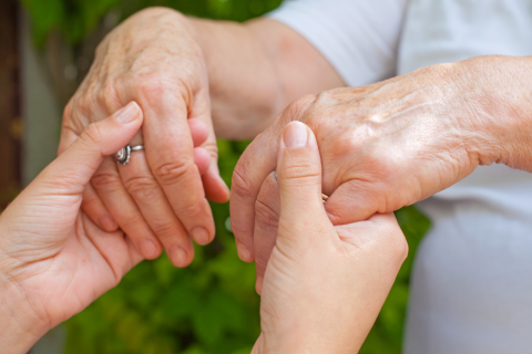 Imagine of Therapist holding hands with Client with Parkinson's Disease